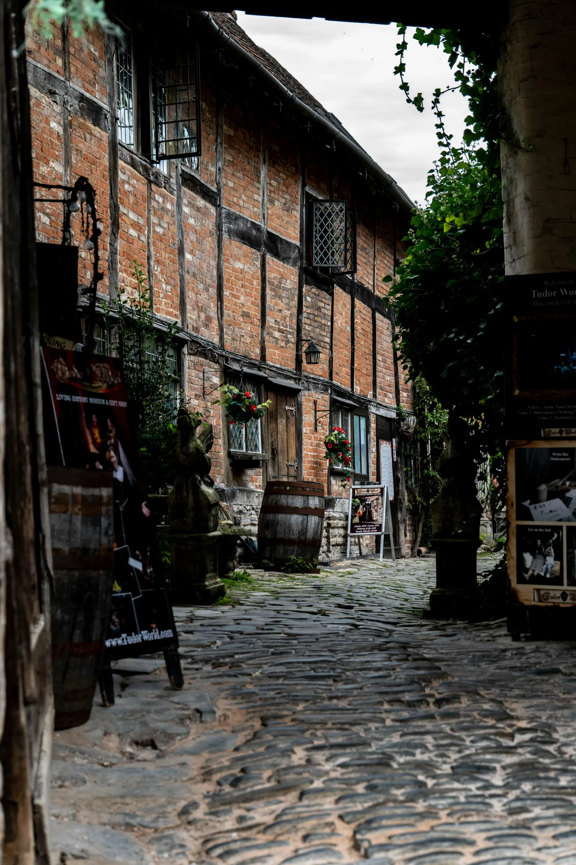 a brick building with a barrel and a sign
