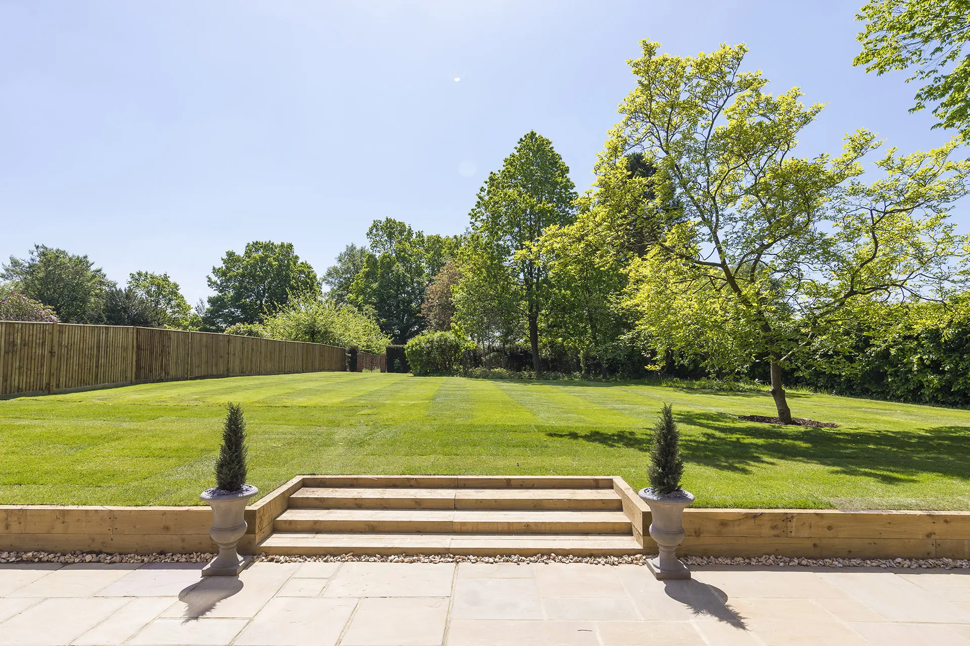a backyard with a lawn and trees
