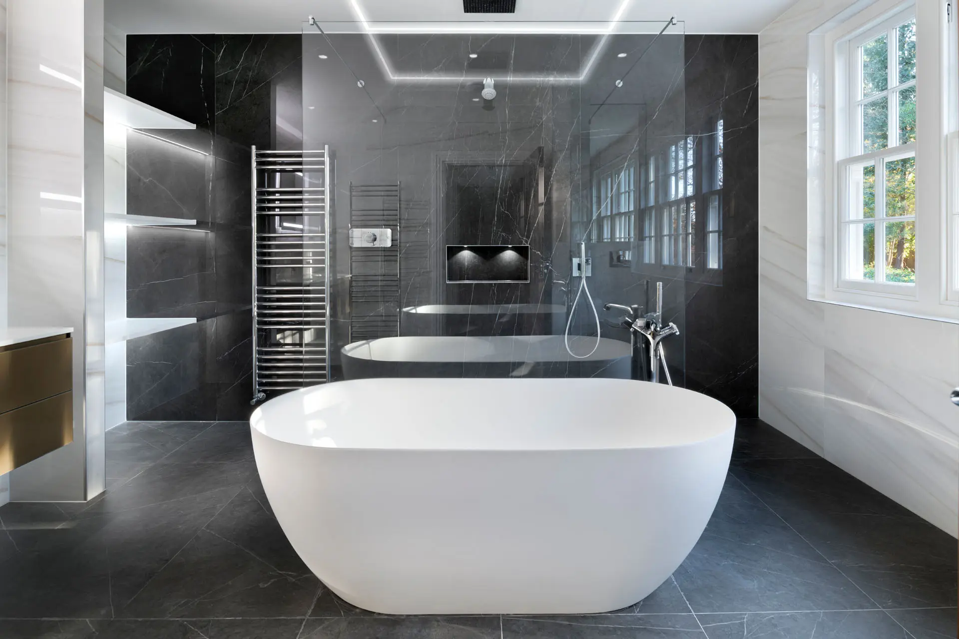 a bathroom with a tub and a shower