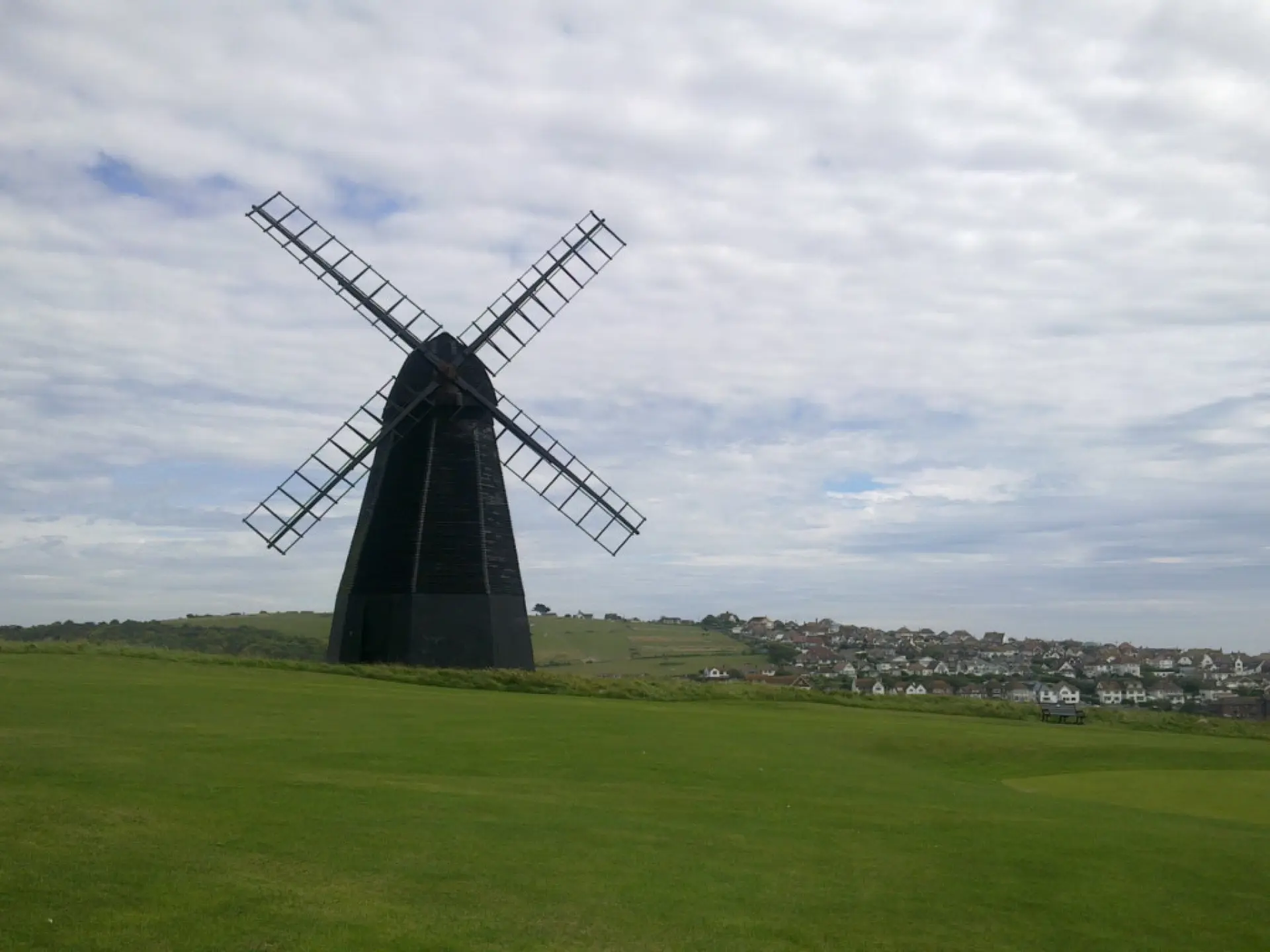 Windmill in a grassy field
