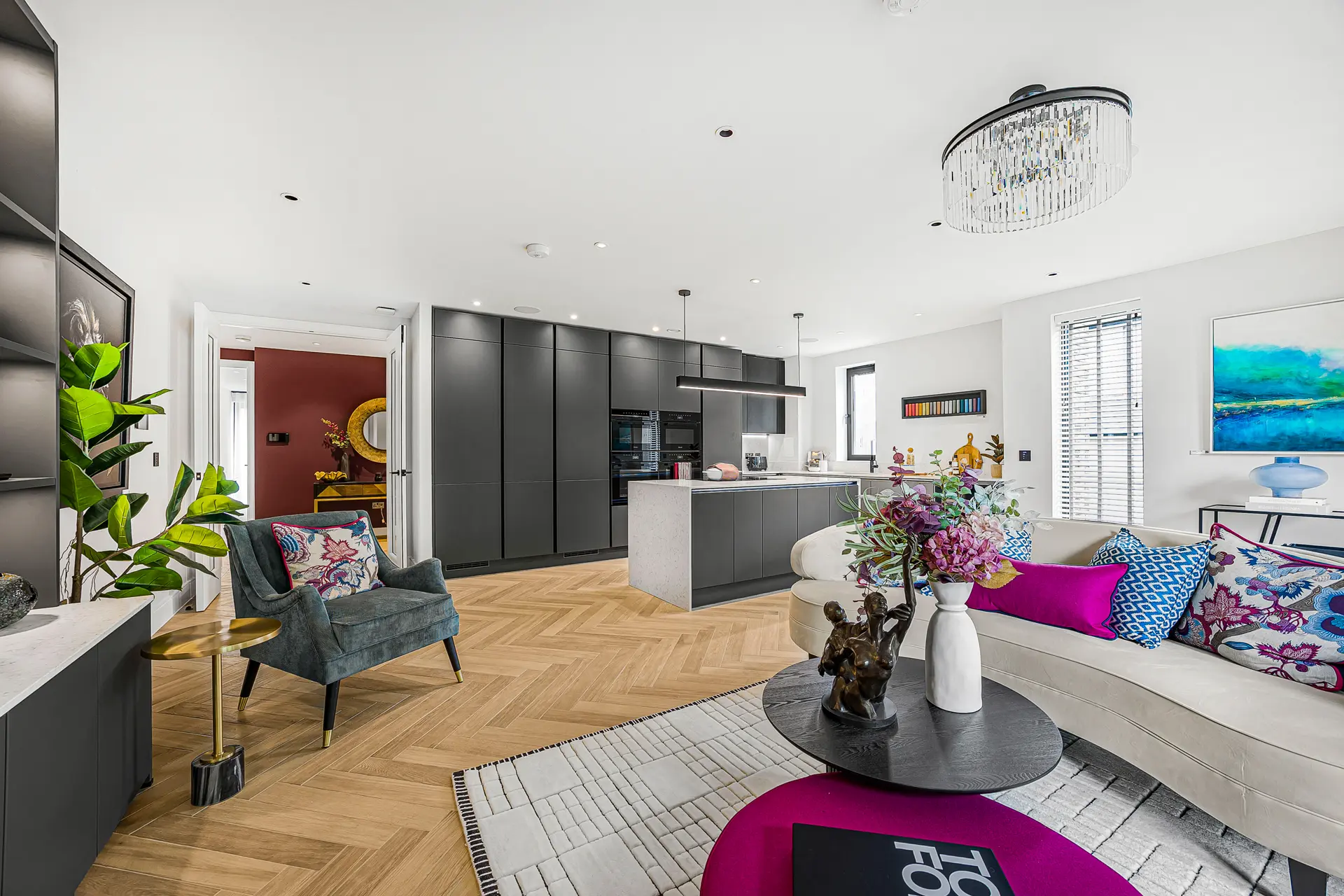 a living room with a kitchen and dining area