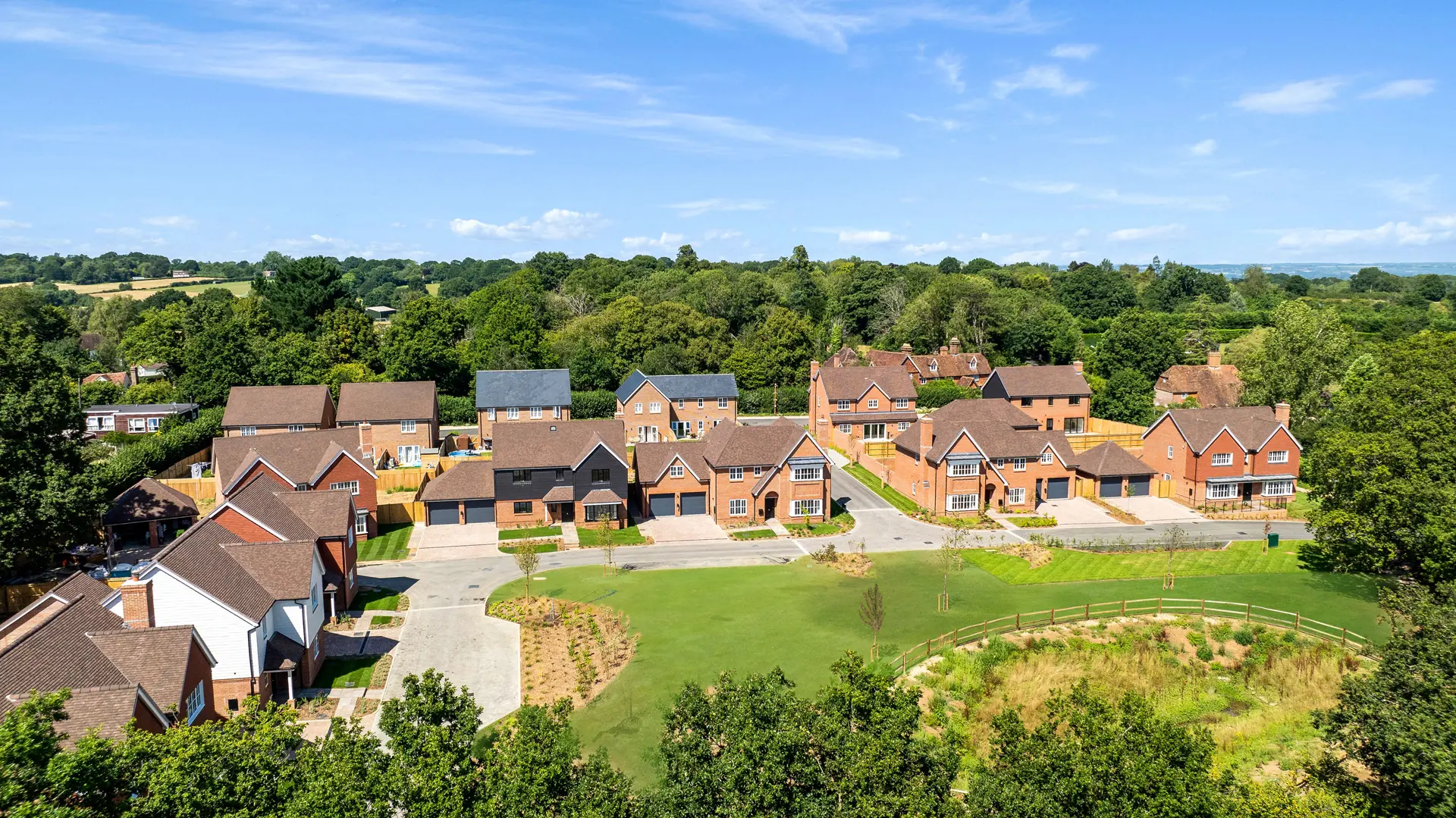 a group of houses with trees in the background