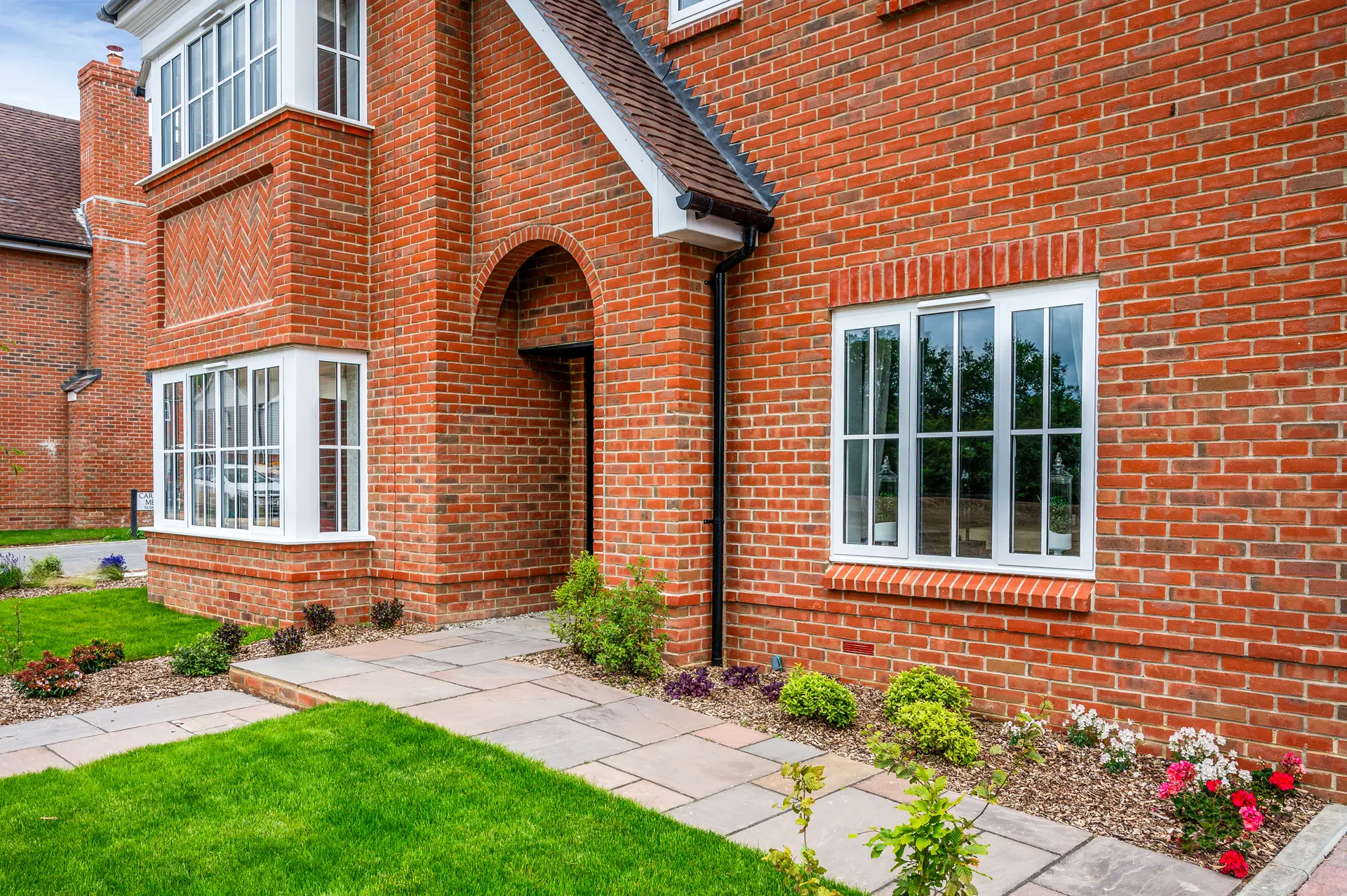 a brick building with a lawn and grass
